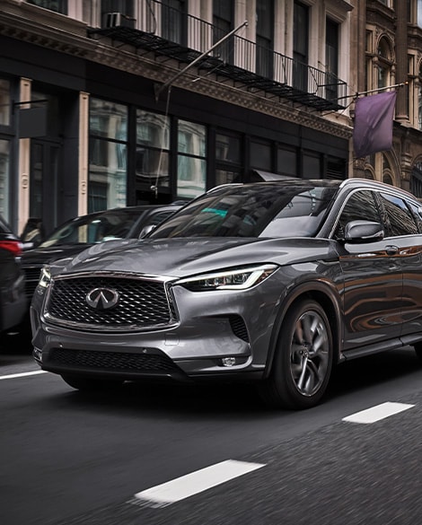 Front profile of 2024 INFINITI QX50 Crossover SUV parked on street