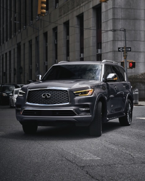 Front profile of 2024 INFINITI QX80 highlighting Hydraulic Body Motion Control System
