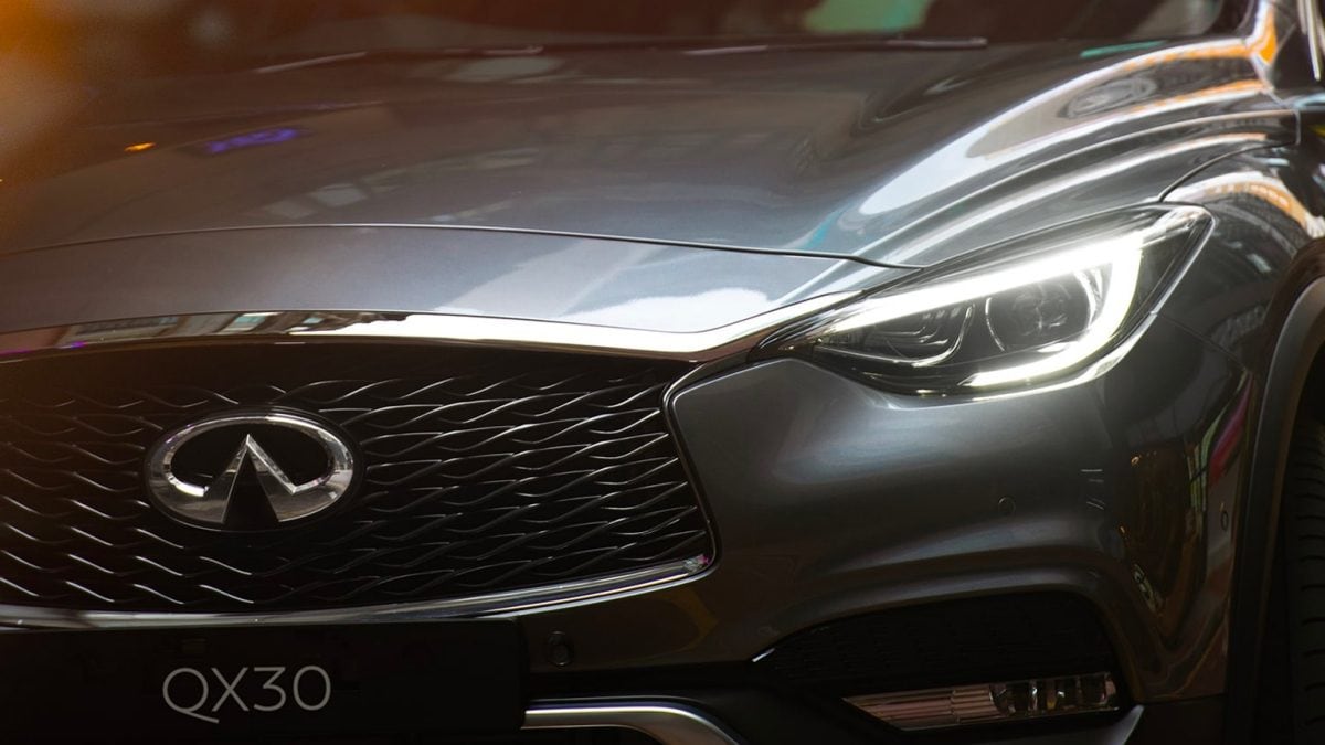 Front Close Up Image Of 2019 INFINITI QX30 Grille And LED Headlights Shown In Graphite Shadow Color